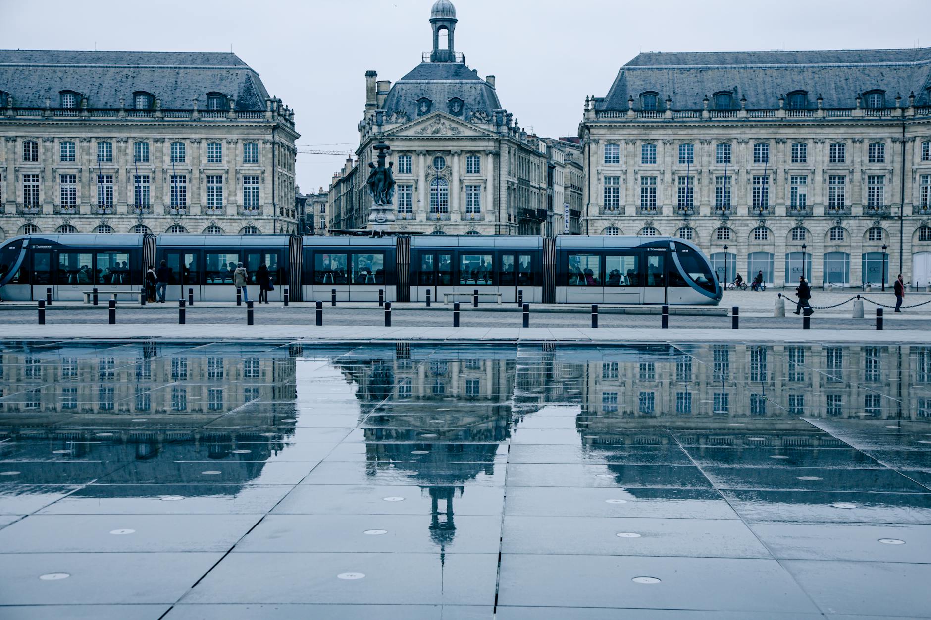 Tram passing by the historic Place de la Bourse in Bordeaux reflecting on the Miroir d eau