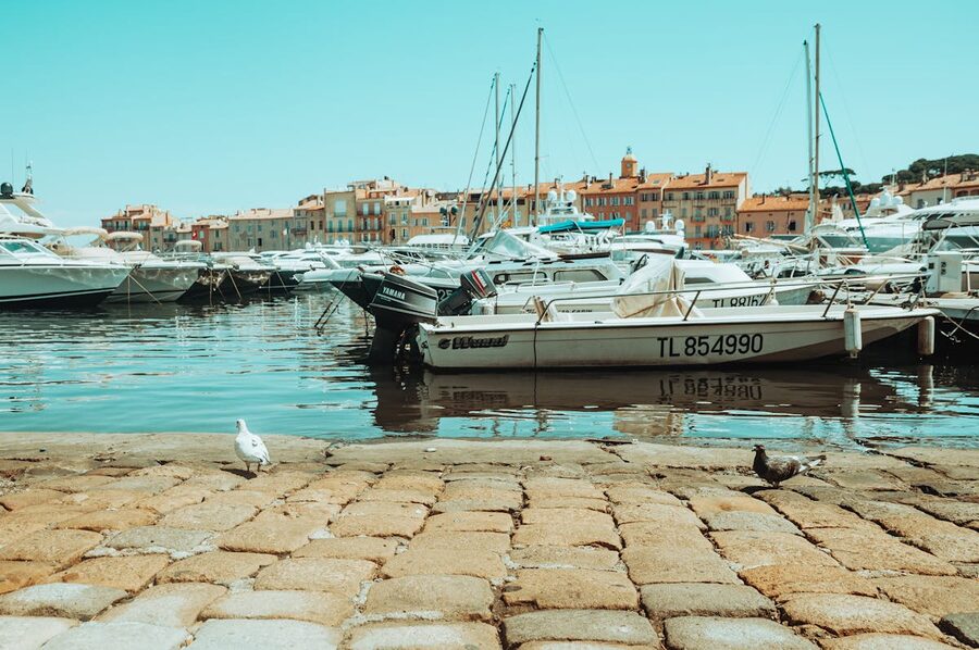 Traditional colourful wooden boats docked in Saint-Tropez harbour on a clear day