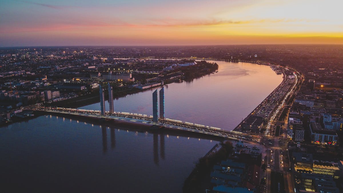 Aerial photograph of a modern bridge crossing the Garonne River in Bordeaux at sunset