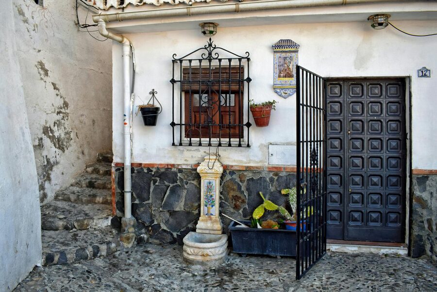Beautiful courtyard with arched columns and potted plants in Granada Spain