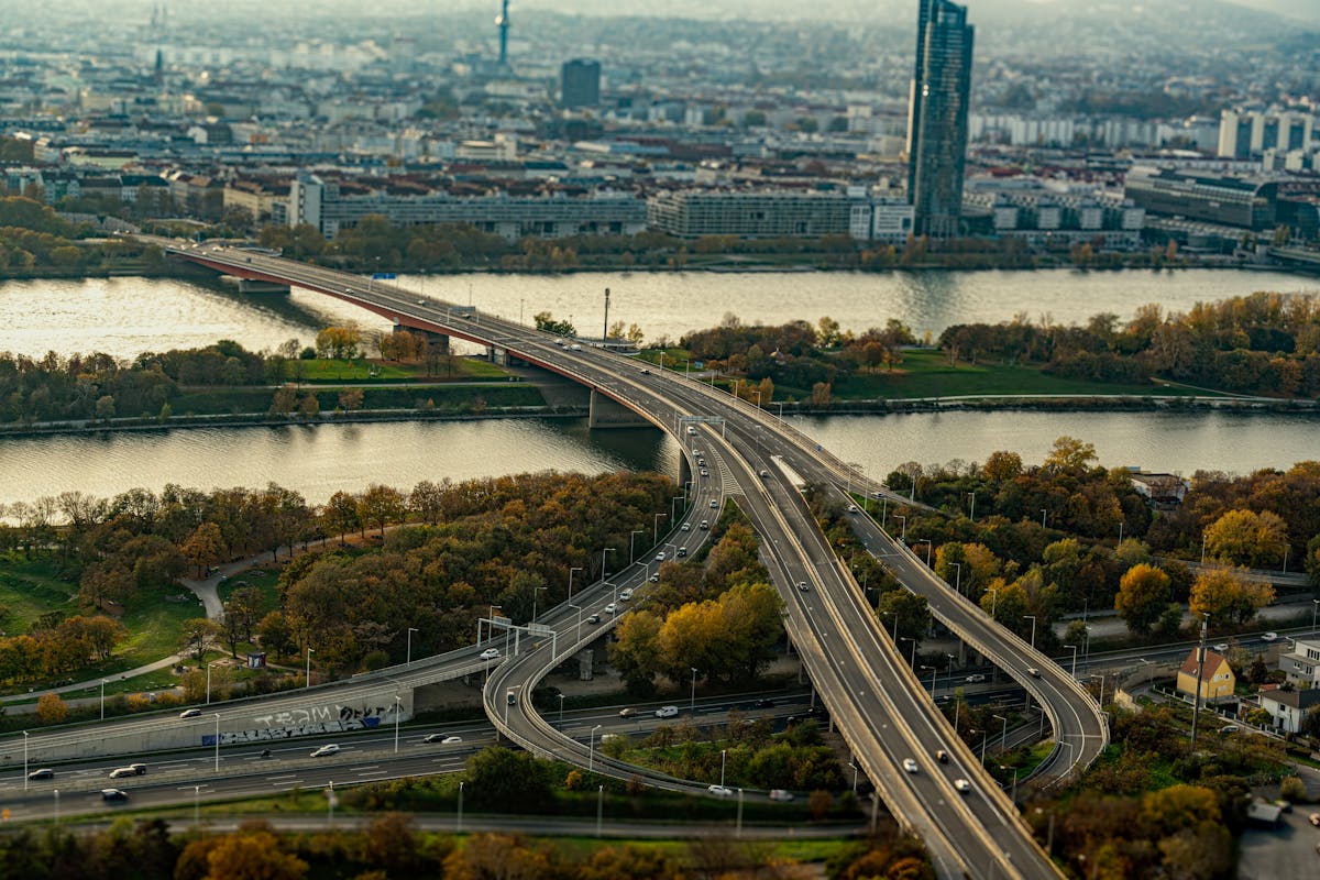 Sweeping aerial view of a modern bridge crossing the Danube River in Vienna with the city skyline