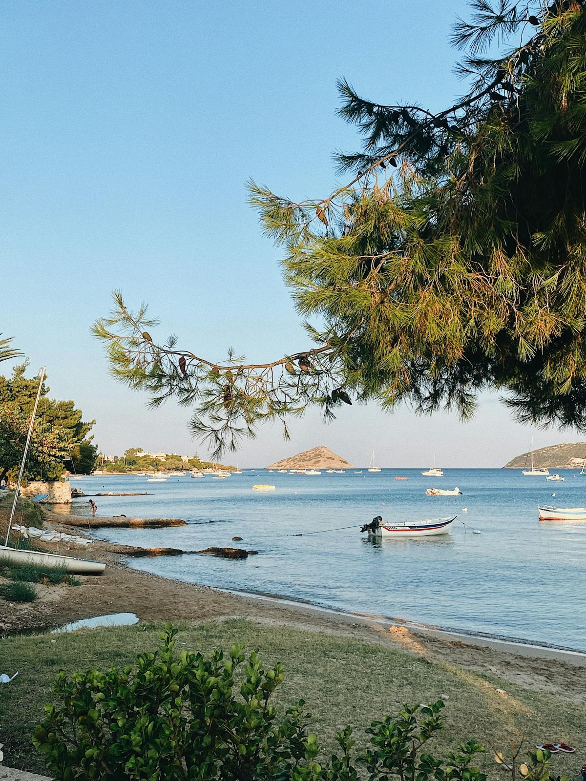 Athens beach with boats under clear sky