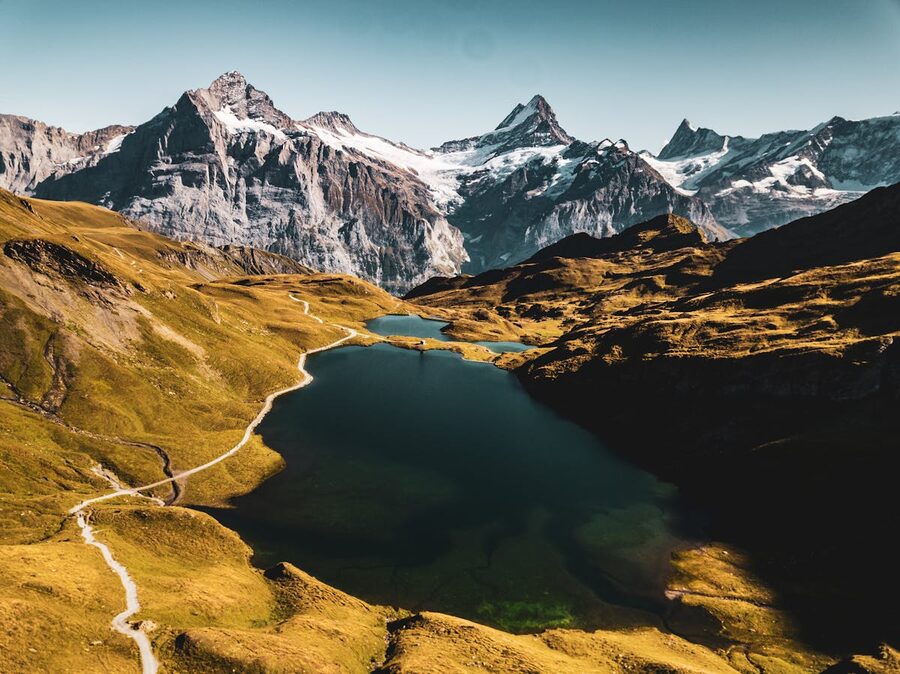 Panoramic view of Bachalpsee lake surrounded by mountain peaks in Grindelwald