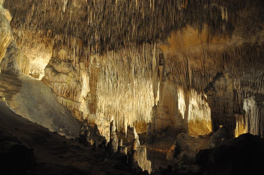 Stalactite formations inside a cave in Mallorca with warm lighting