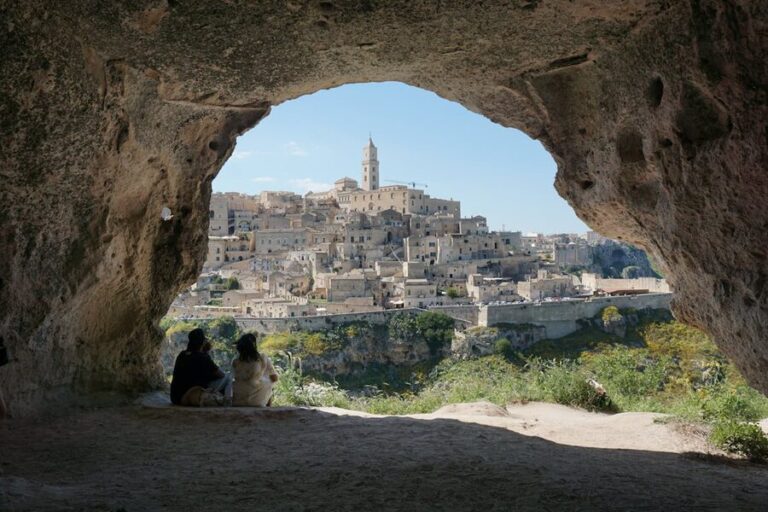 Matera ancient cave dwellings viewed through a natural stone archway