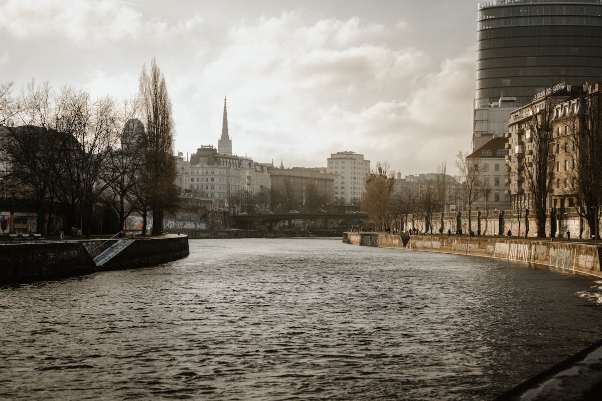 Peaceful view along the Danube Canal in Vienna with historic buildings lining the waterway