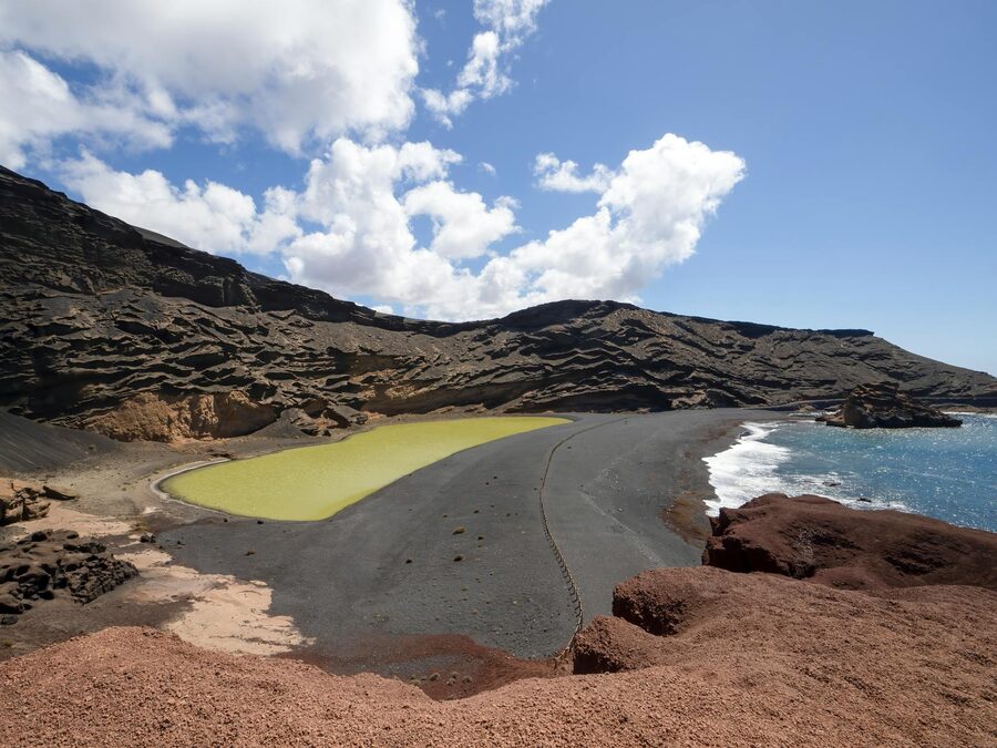 El Golfo green lagoon and rocky volcanic coastline in Lanzarote Spain
