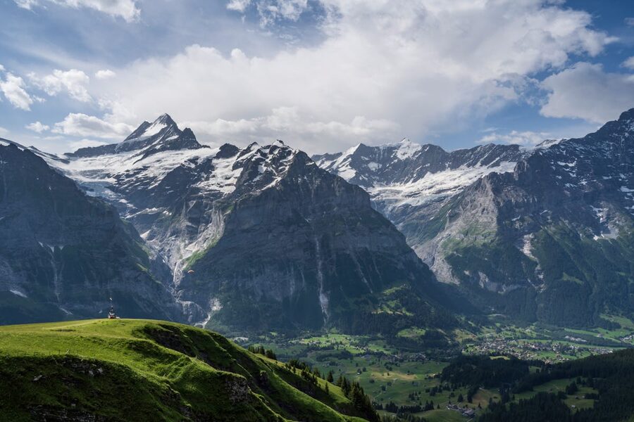 Panoramic view of the Jungfrau region showing green valleys and Alpine peaks in the Swiss Alps