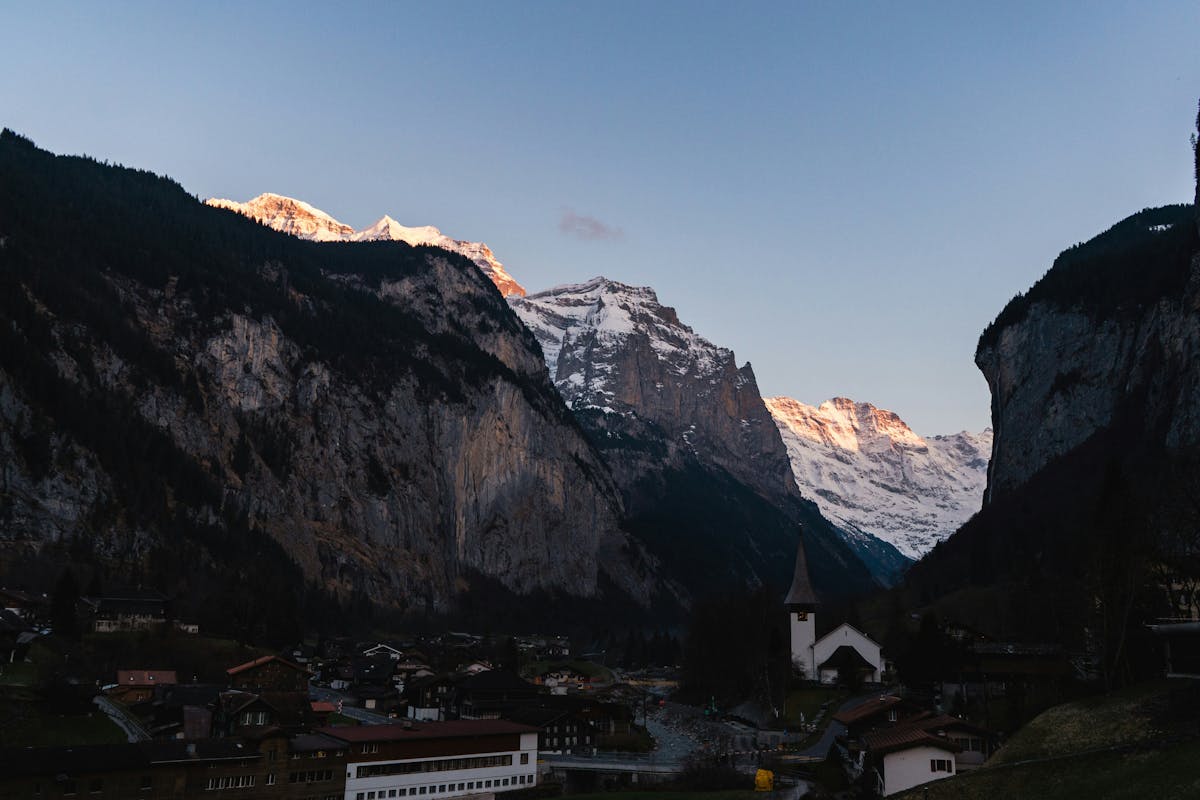 Lauterbrunnen valley bathed in golden sunset light with snow-capped mountains