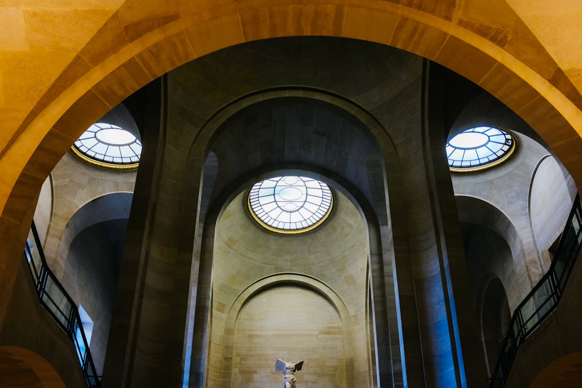 The Winged Victory of Samothrace statue on the grand staircase inside the Louvre Museum