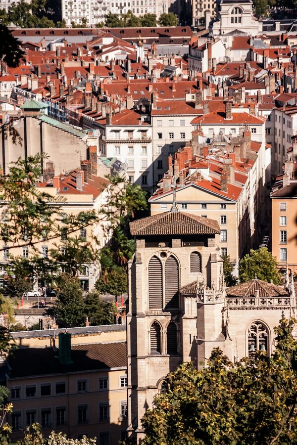 Aerial view of Lyon showing historic terracotta rooftops and Fourviere hill
