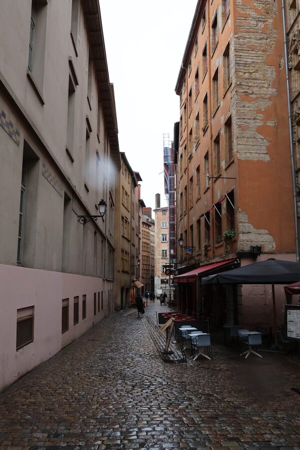 Narrow cobblestone street lined with Renaissance buildings in Vieux Lyon
