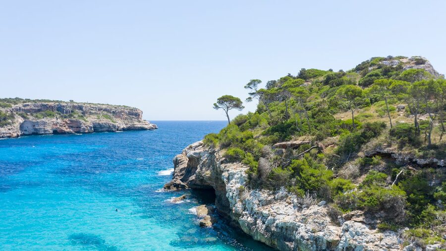 Mallorca rocky cliffs and clear blue Mediterranean sea on a sunny day