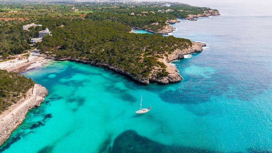 Aerial view of a turquoise cove with crystal clear water in Mallorca