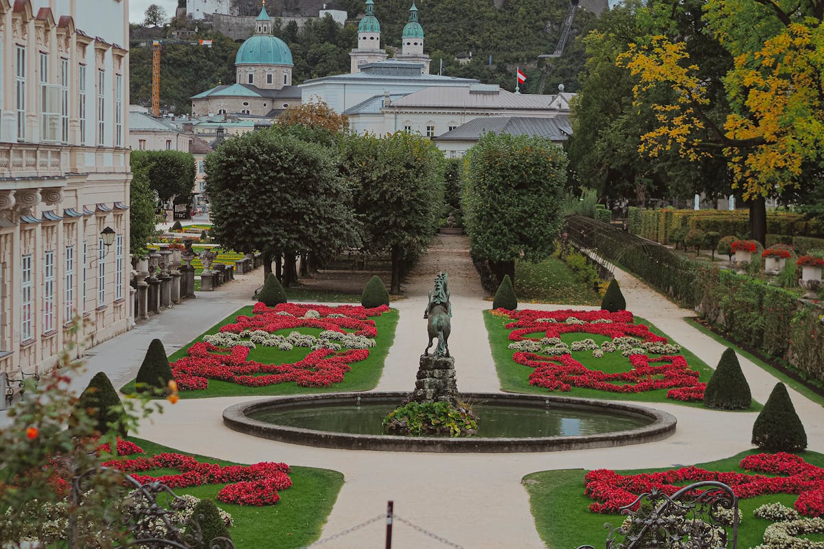 Mirabell Gardens with autumn foliage and Salzburg Cathedral in the background