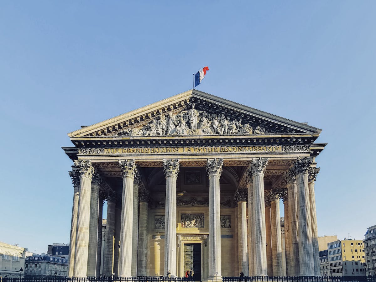Front view of the Paris Pantheon with its Corinthian columns and French flag