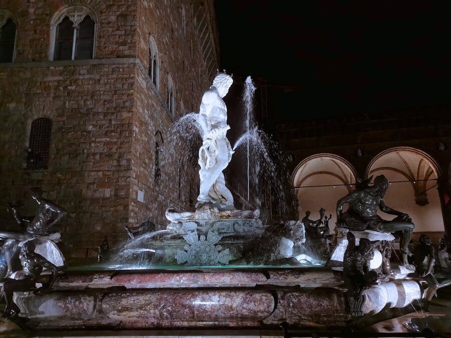 Fountain of Neptune illuminated at night in Piazza della Signoria, Florence