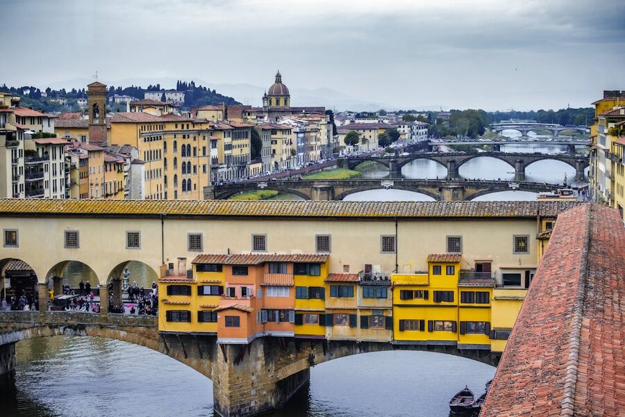 Panoramic view of Florence's Ponte Vecchio spanning the Arno river with city skyline