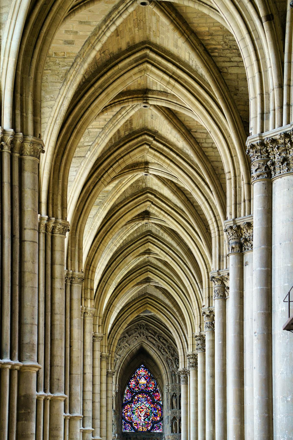 Gothic architecture inside Reims Cathedral with detailed arches and stained glass