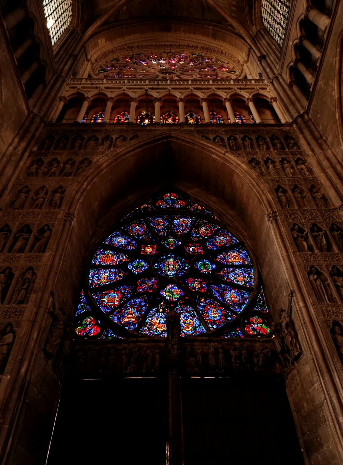 Intricate stained glass Rose Window inside Reims Cathedral in Grand Est France