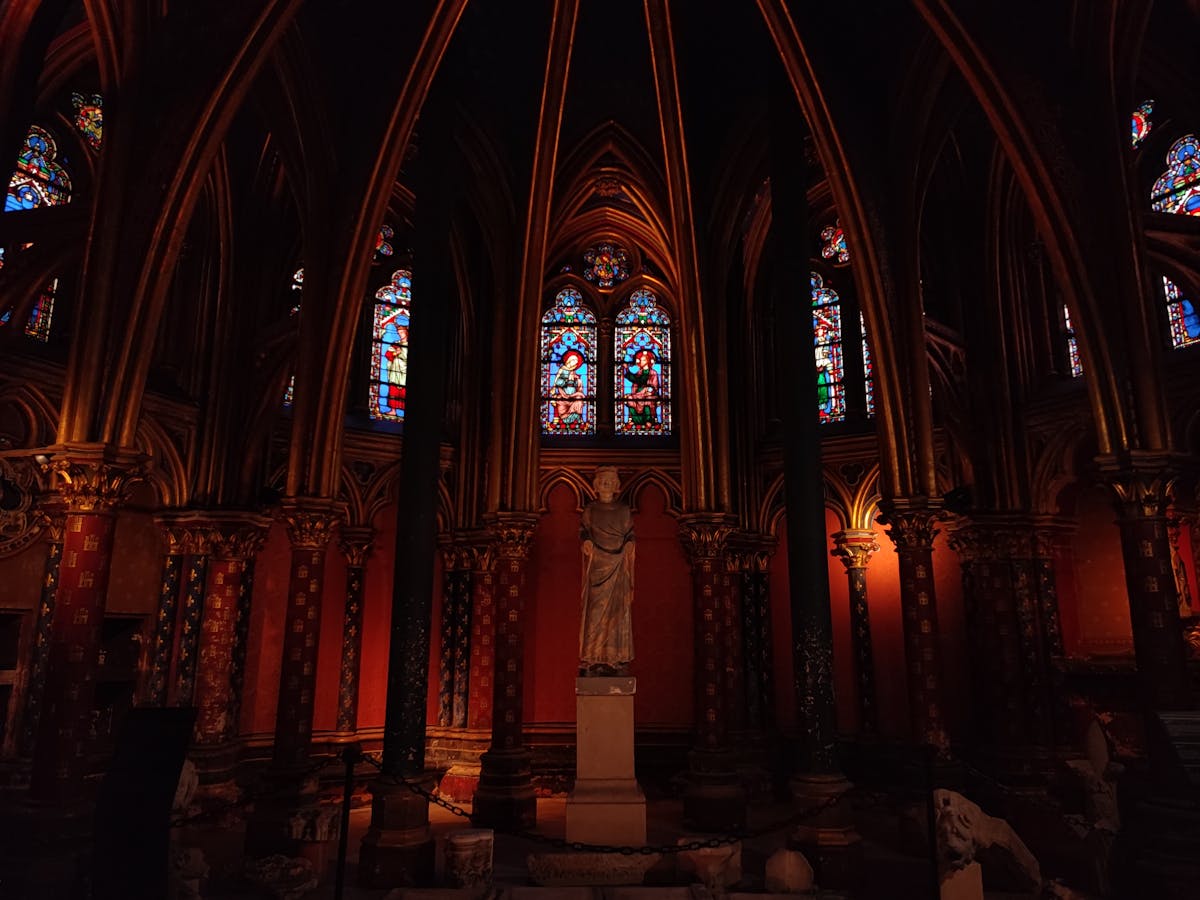 Gothic interior of Sainte-Chapelle with tall stained glass windows and vaulted ceiling