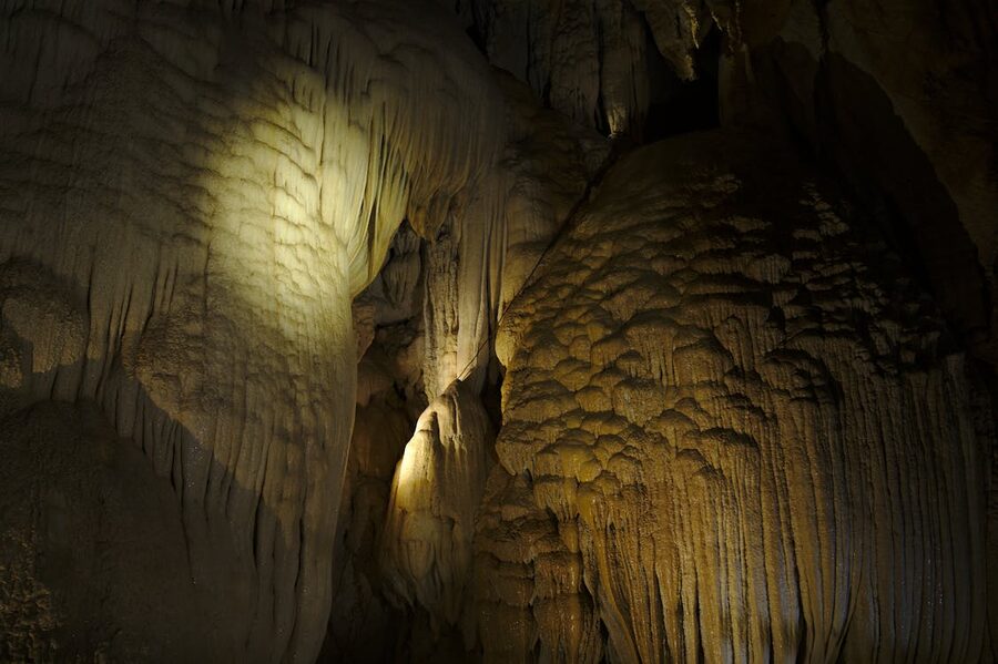 Stalactites and cave formations illuminated with natural lighting