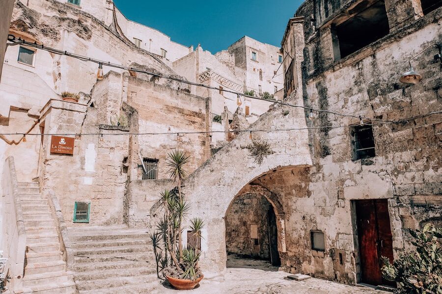 Charming stone alleyway with potted plants in Matera old town