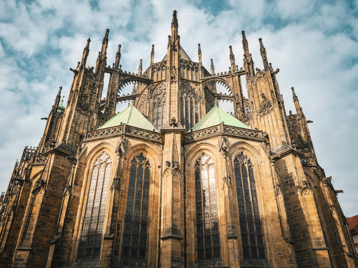 Dramatic Gothic architecture of St. Vitus Cathedral against a stormy sky