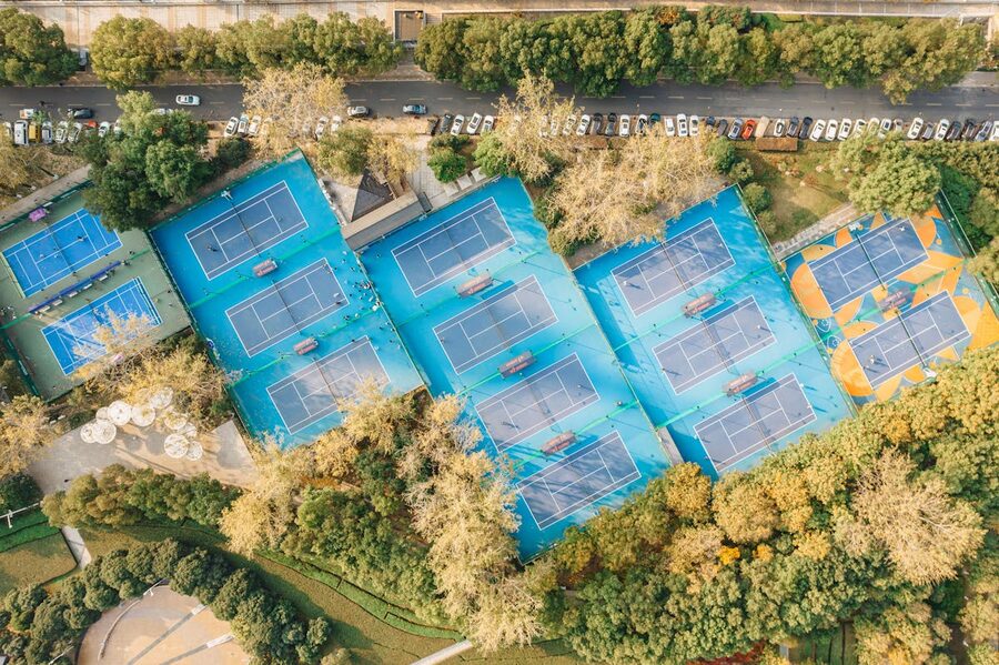 Aerial view of several tennis courts arranged in a sports complex