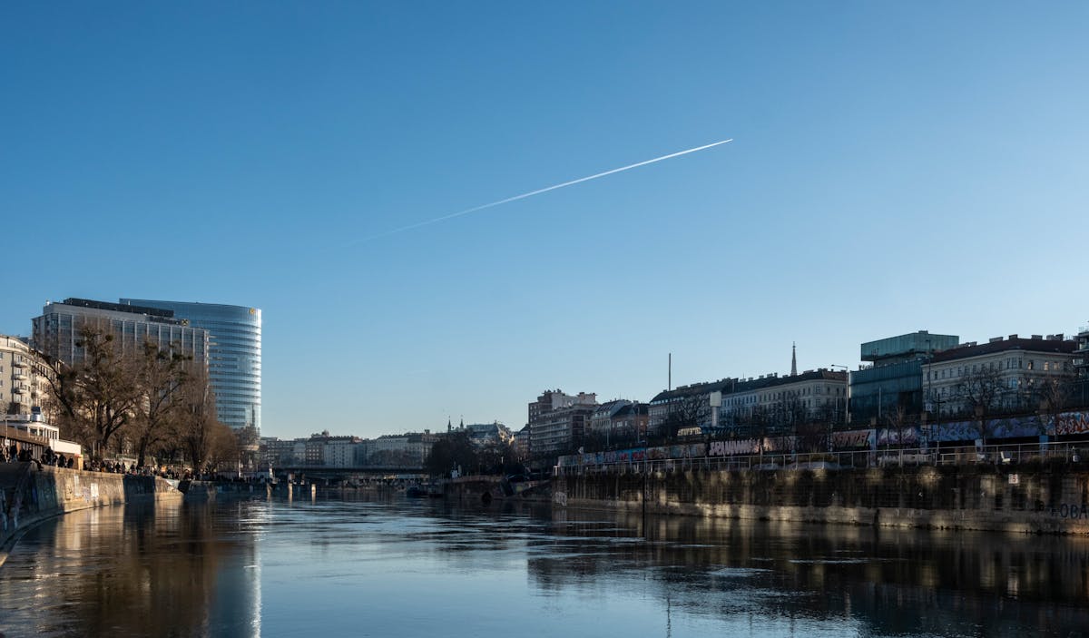 A clear daylight view of Vienna skyline and the Danube River