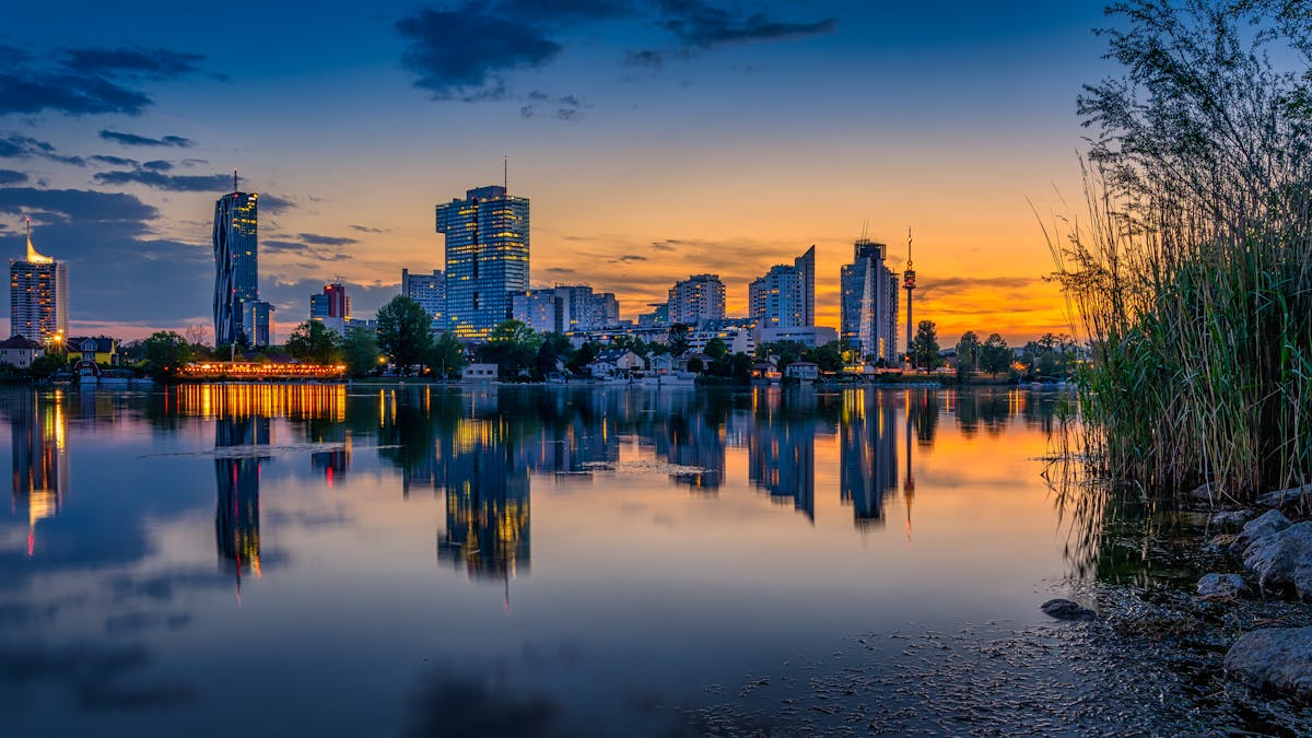 Stunning sunset over Vienna with the city skyline reflecting in the Danube River