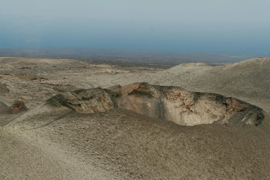 A volcanic crater with dramatic red-hued slopes in Lanzarote Canary Islands