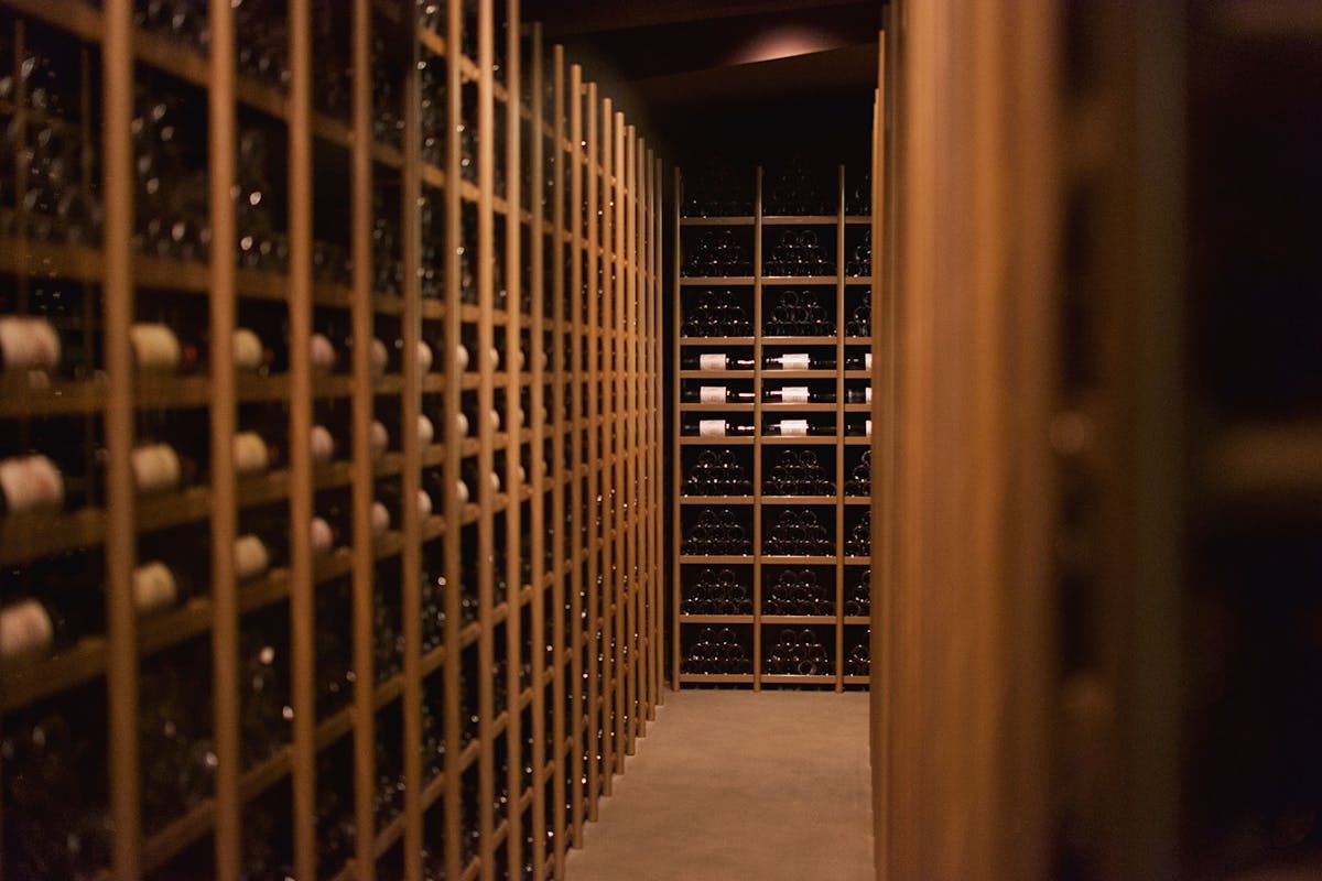 Elegant wine cellar display with rows of wine bottles in Pauillac France