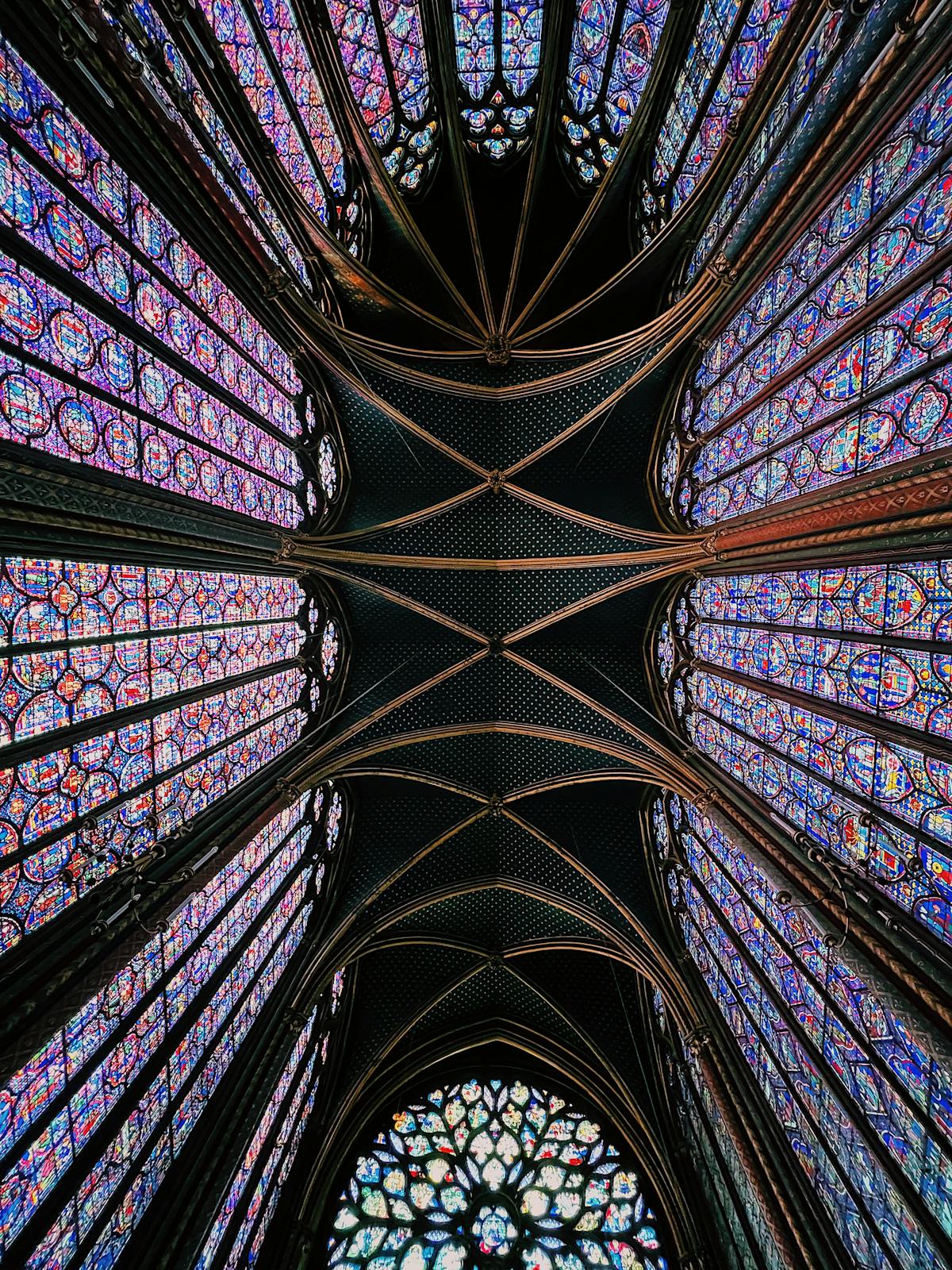 Detailed stained glass panels of Sainte-Chapelle illuminated by morning sunlight