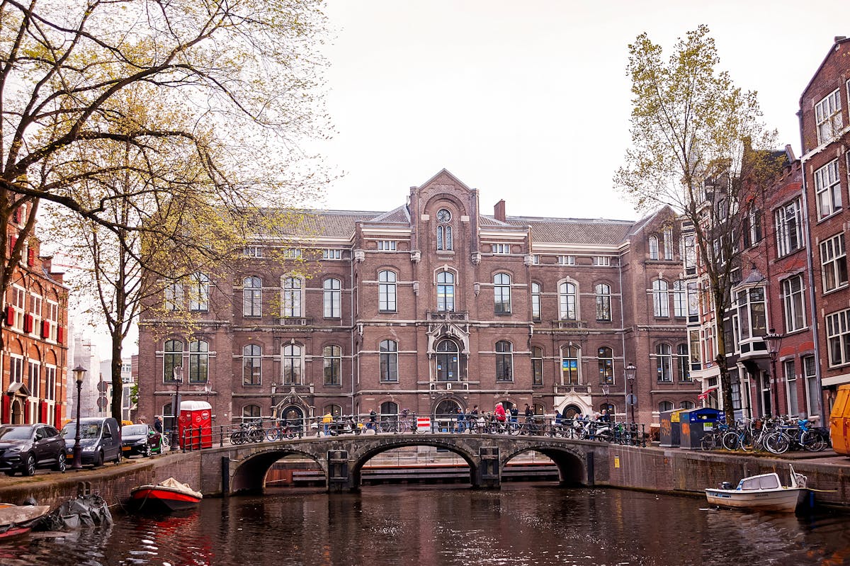 Historic Amsterdam canal with bridge and building facade