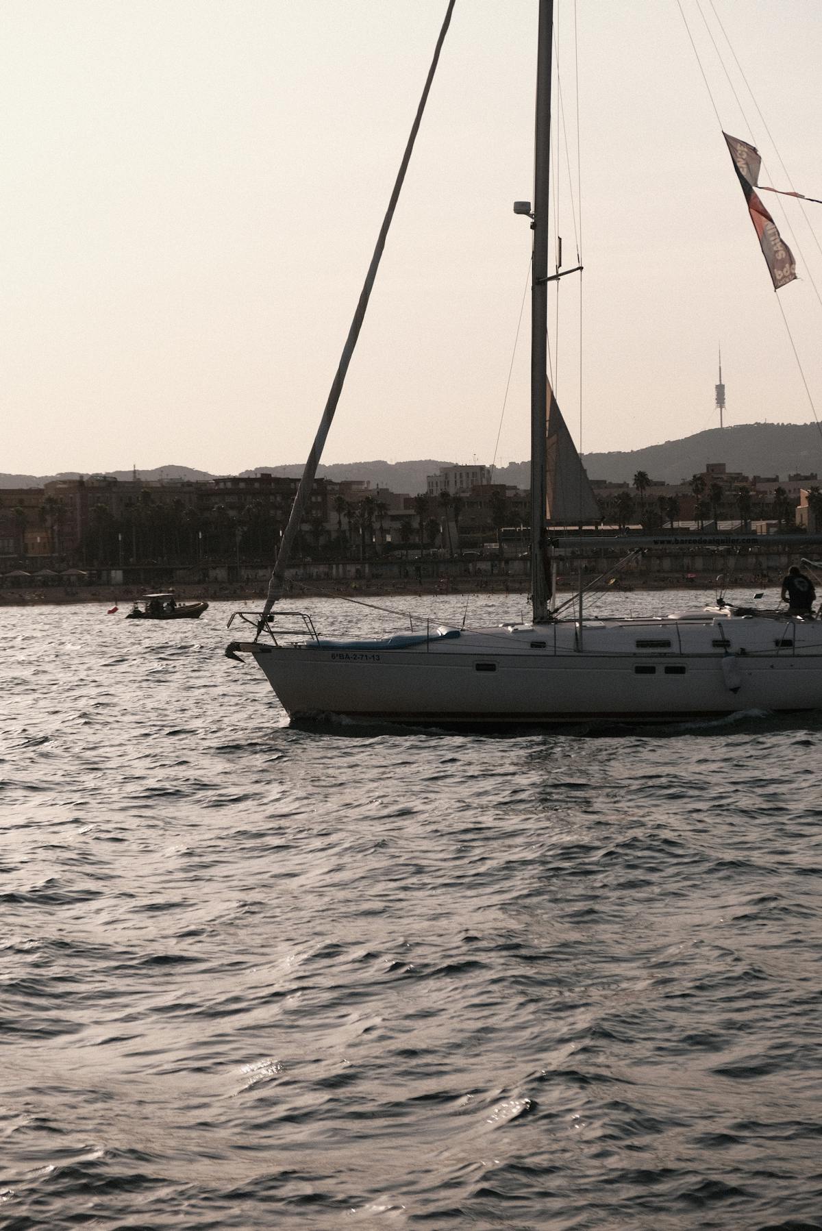 Sailboat at sunset with the Barcelona skyline and Sagrada Familia