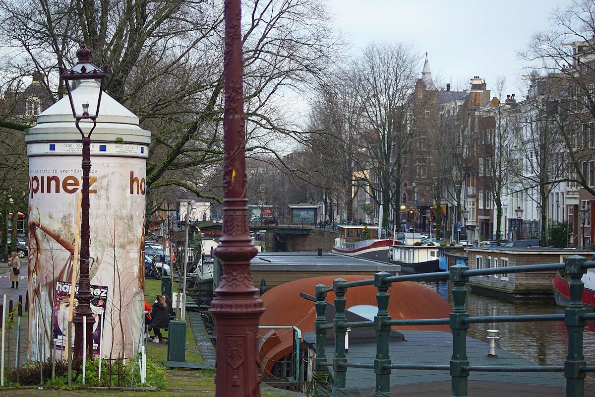Charming Amsterdam canal with traditional boats and houses