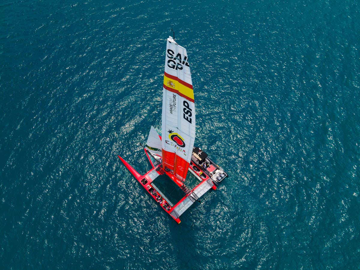 Catamarans on a sandy beach under a dramatic cloudy sky