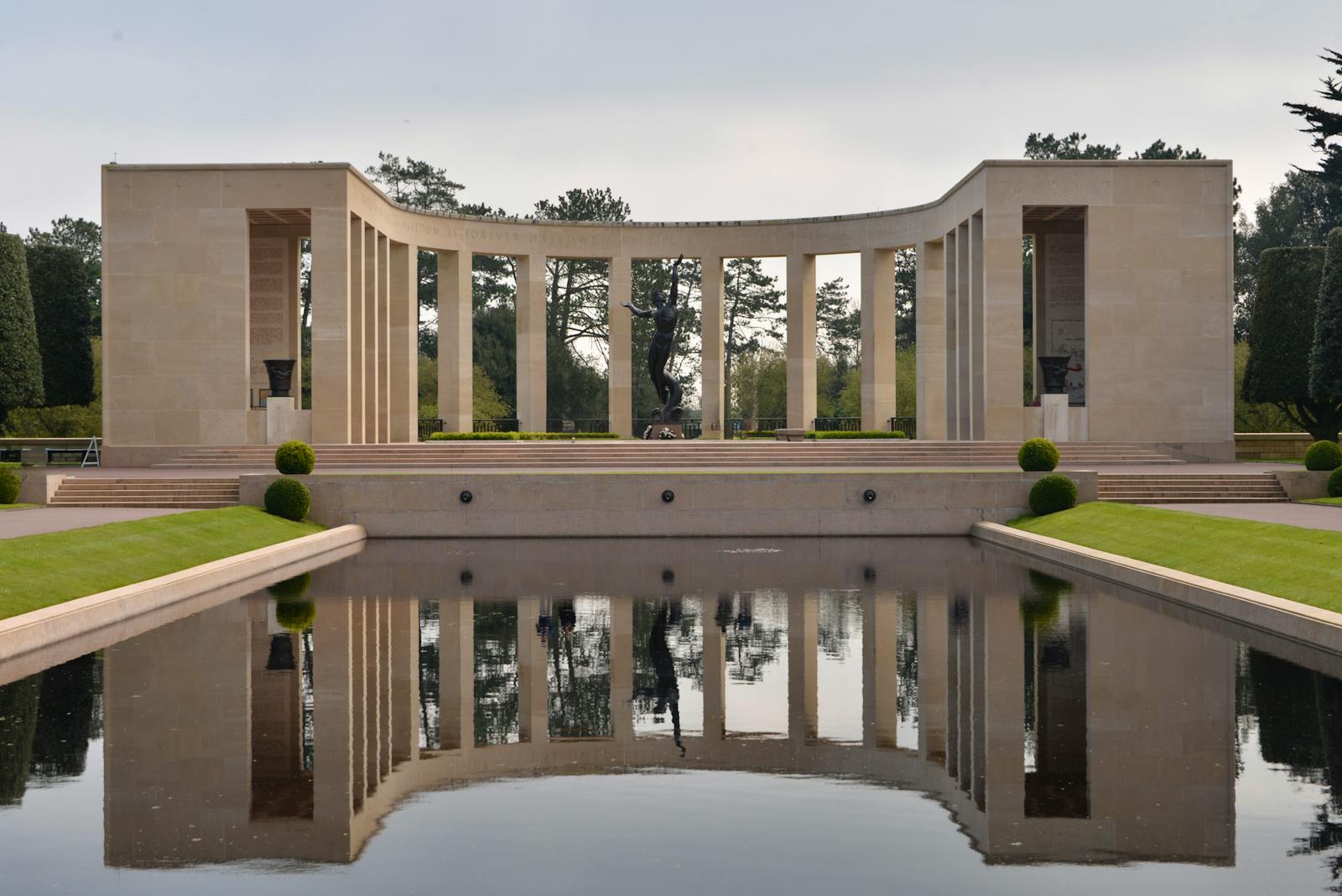 Reflective pool and Spirit of American Youth statue at Normandy Cemetery