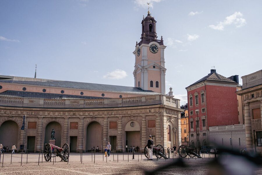 Historic courtyard with prominent clock tower in Stockholm Old Town