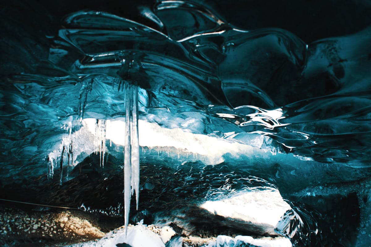 Icicle formations hanging from the ceiling of an ice cave in Iceland