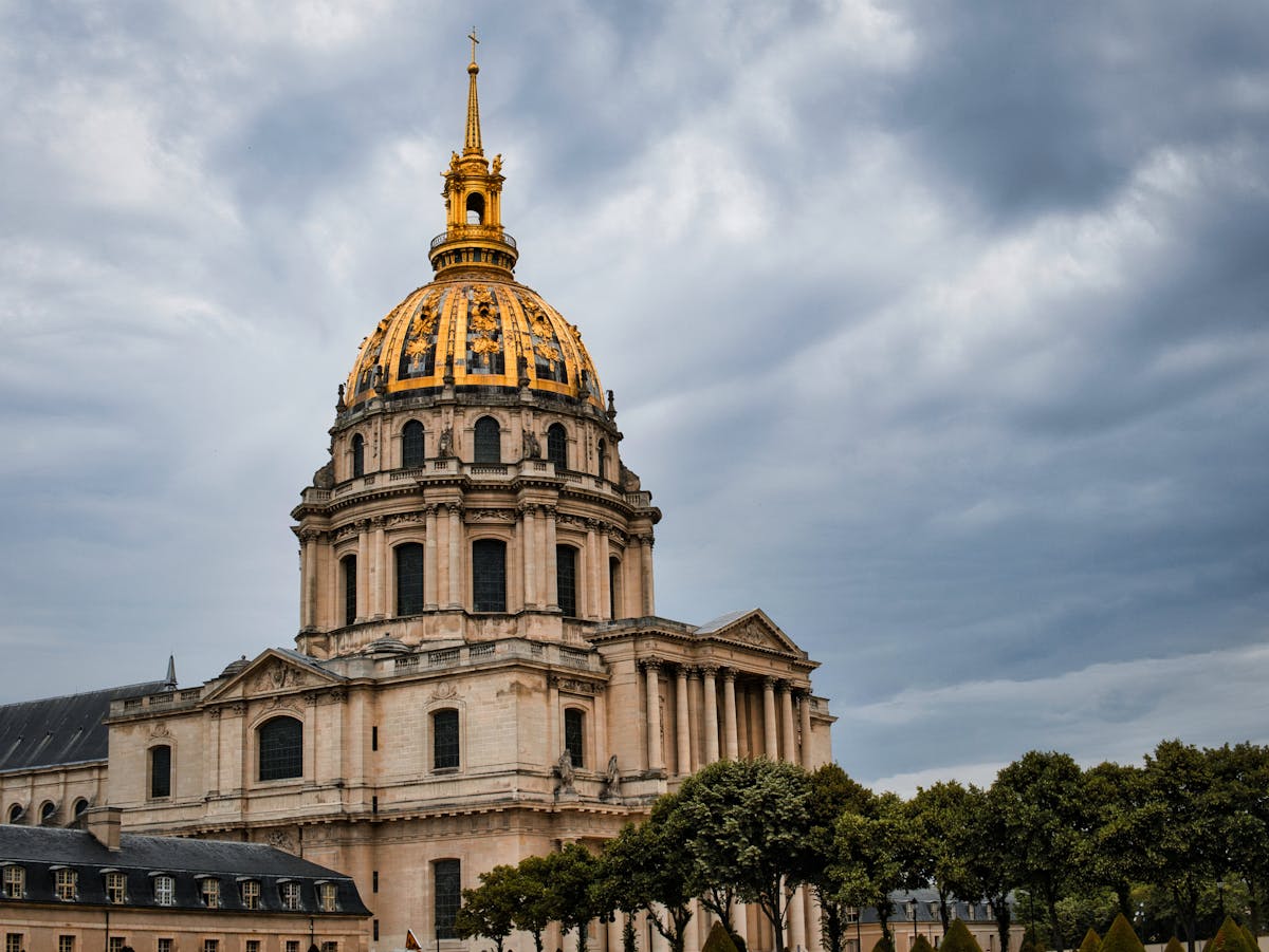 Hotel des Invalides building in Paris under dramatic cloudy sky