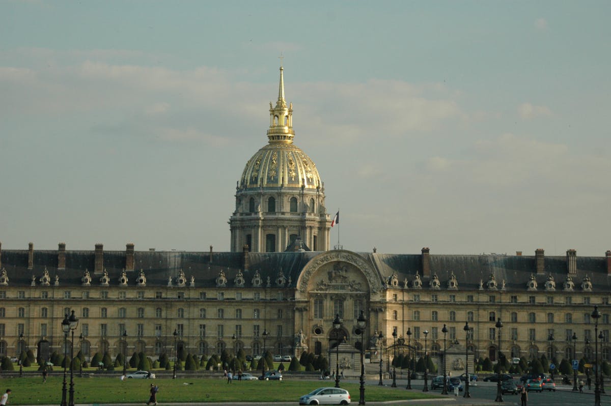 Close-up view of Les Invalides golden dome and stone facade in Paris