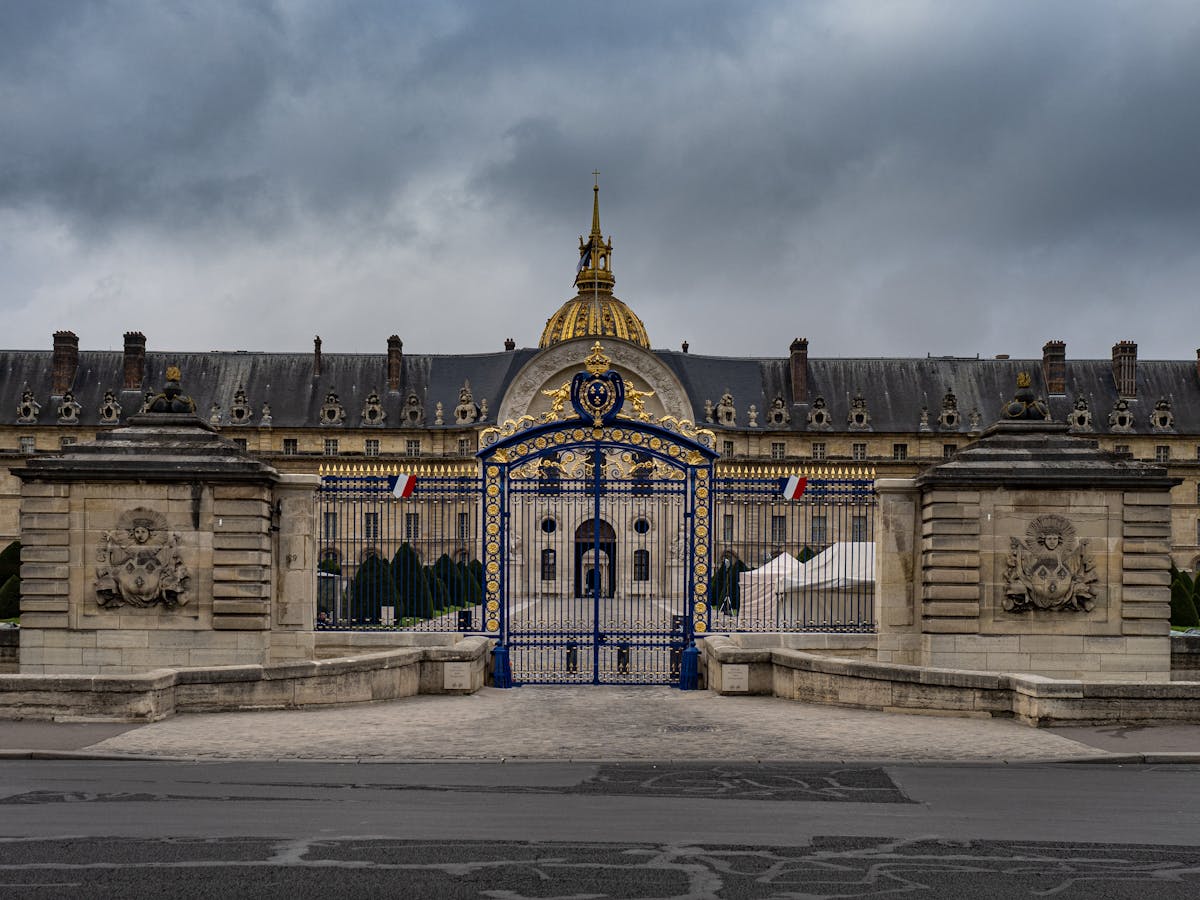 The ornate iron gates of Les Invalides with the golden dome visible behind