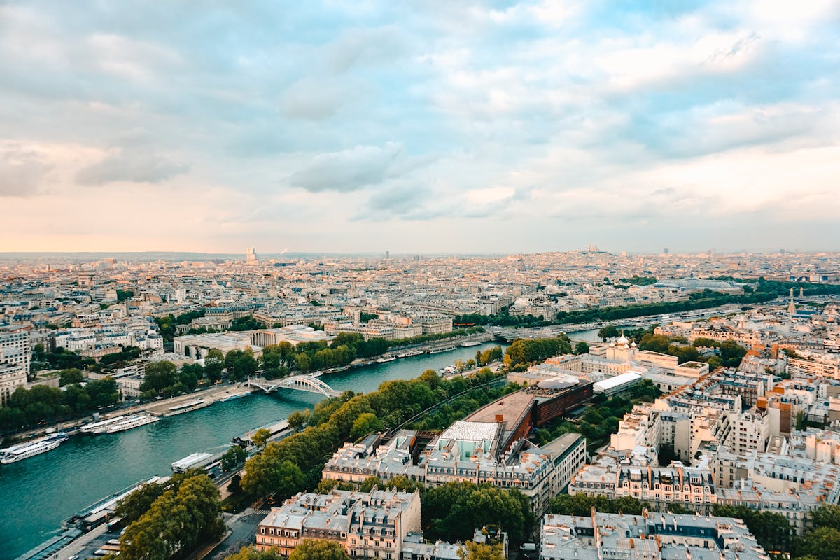 Panoramic aerial view of Paris with the Seine River and landmarks during sunset