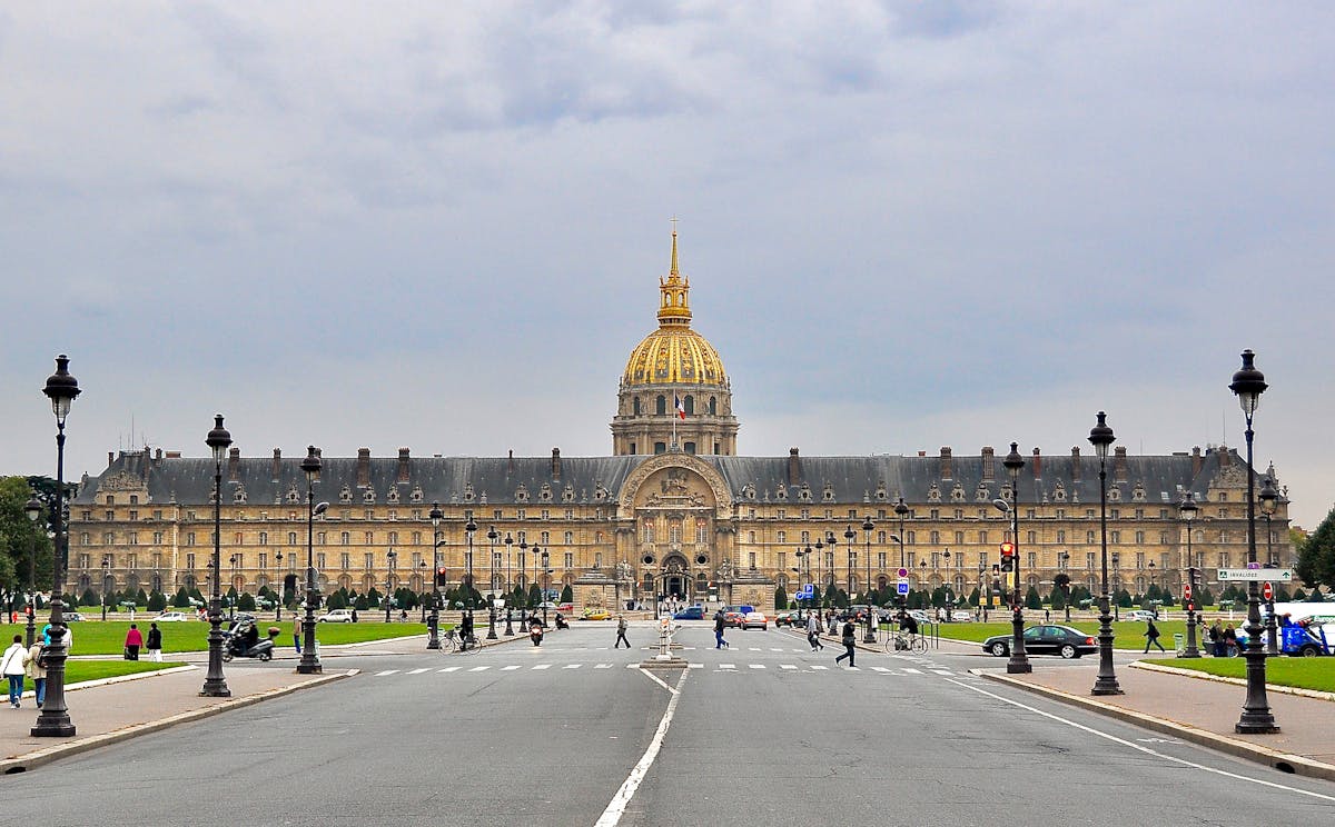 People walking towards Les Invalides with its golden dome in Paris