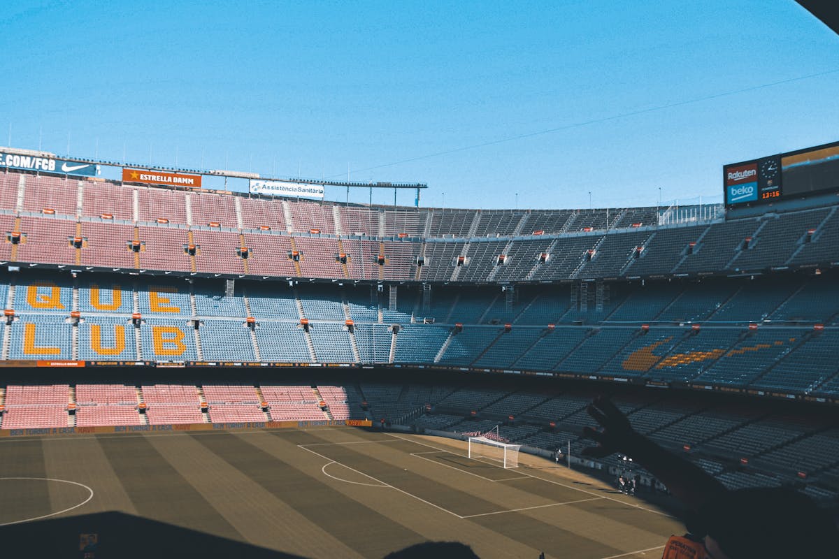 Interior shot of Camp Nou stadium showing empty seats and the football pitch