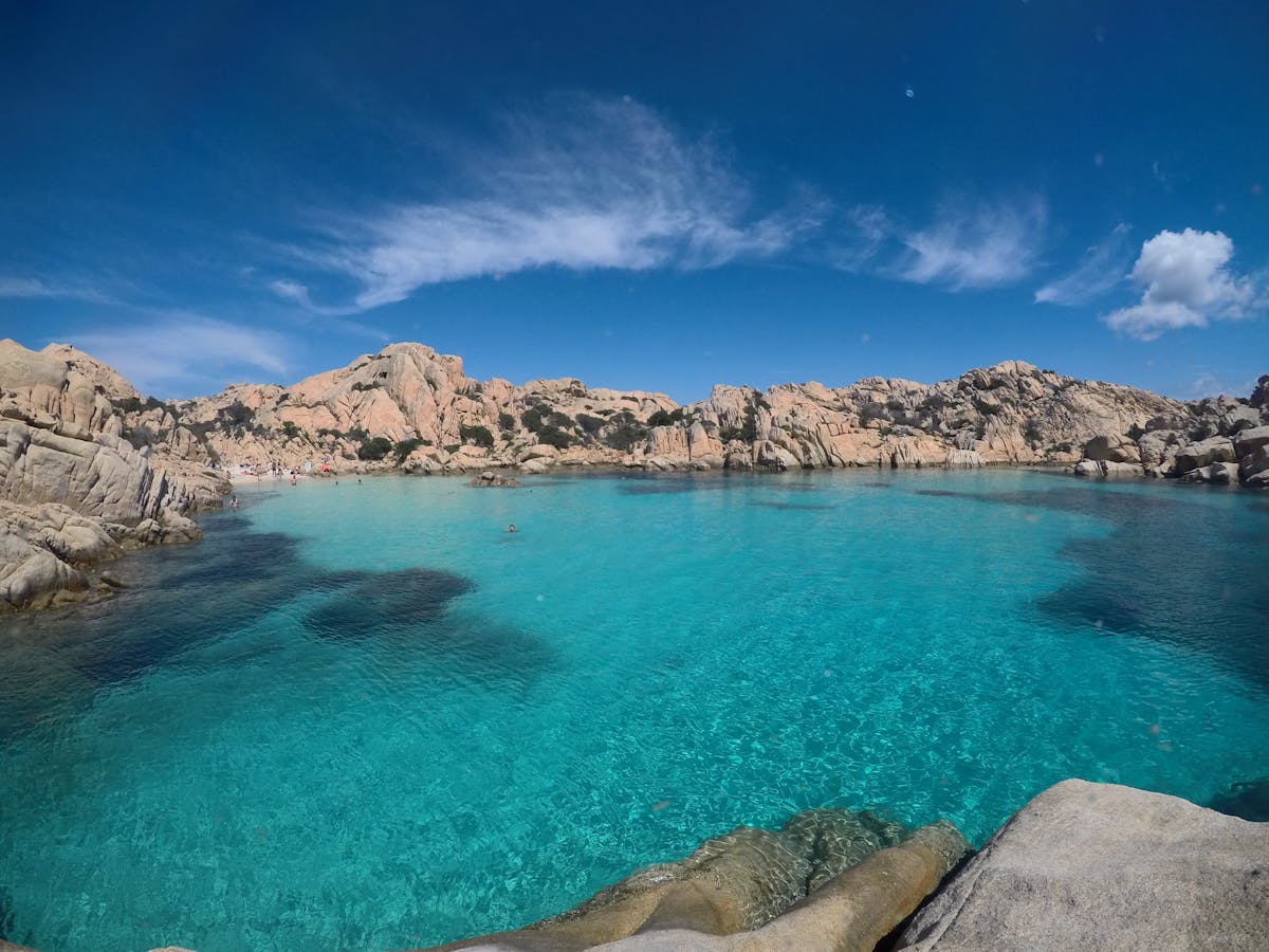 Crystal clear blue waters along the rocky shores of La Maddalena