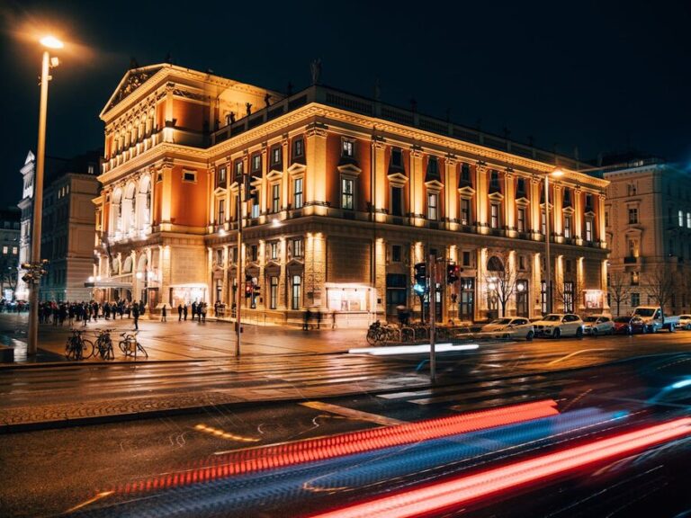 Ornate classical concert hall interior with golden chandeliers and balconies