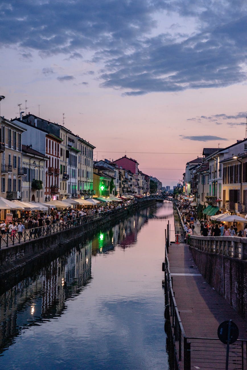 Navigli canal in Milan with colorful buildings and outdoor cafes along the waterway